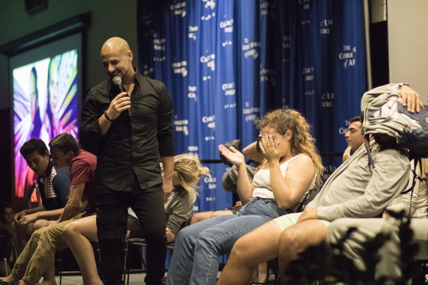 Audience volunteers laughing during Eric Mina's show