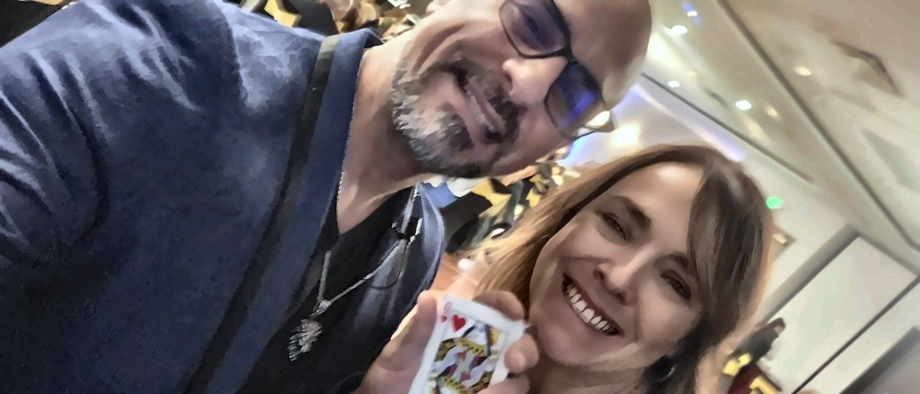 Eric Mina with the event organizer holding her card at the end of the finale